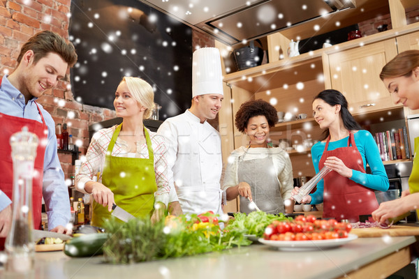 happy friends and chef cook cooking in kitchen Stock photo © dolgachov