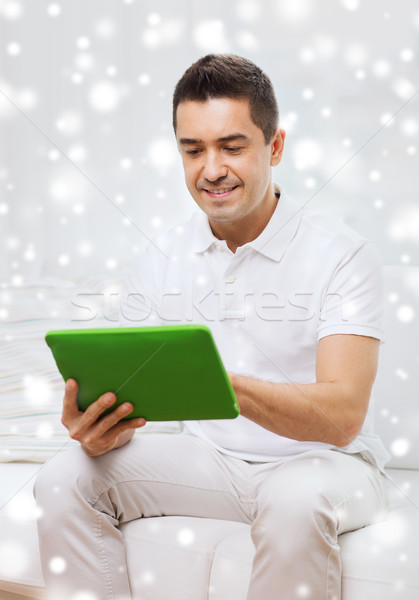 smiling man working with tablet pc at home Stock photo © dolgachov