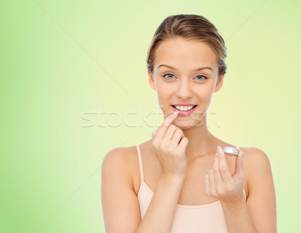 Uśmiechnięty młoda kobieta warga balsam usta Zdjęcia stock © dolgachov