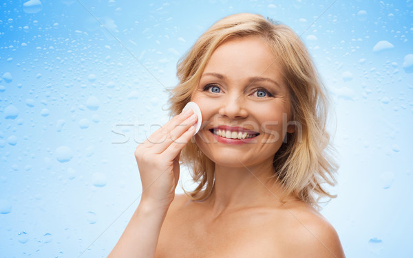 happy woman cleaning face with cotton pad Stock photo © dolgachov
