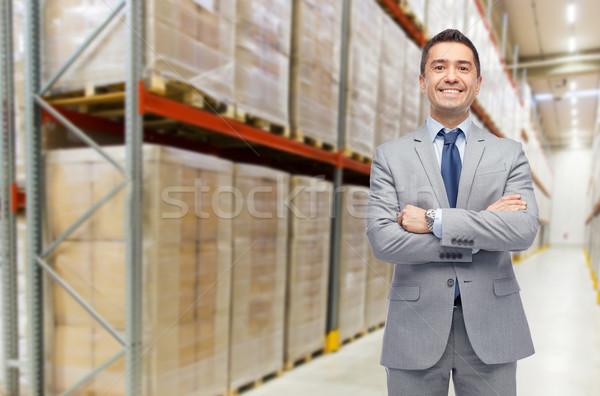happy man in suit and tie over warehouse Stock photo © dolgachov