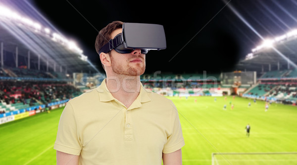 man in virtual reality headset over football field Stock photo © dolgachov