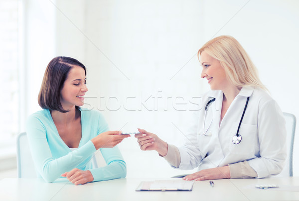 doctor giving tablets to patient in hospital Stock photo © dolgachov