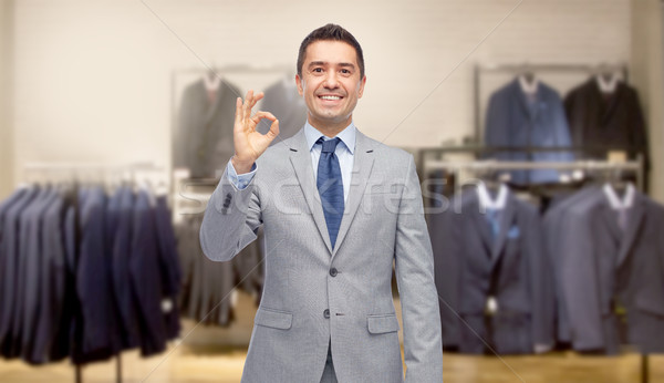 happy businessman in suit over clothing store Stock photo © dolgachov