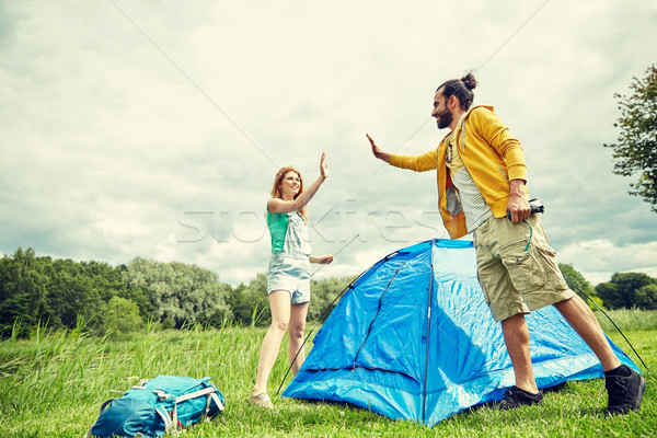 happy couple setting up tent outdoors Stock photo © dolgachov