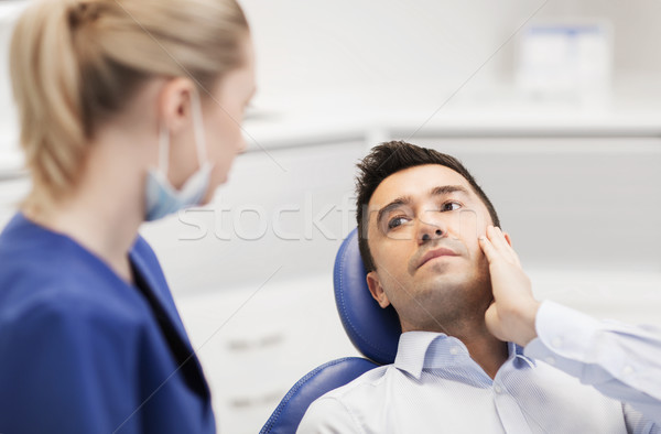 Femeie dentist masculin pacient durere de dinti oameni Imagine de stoc © dolgachov