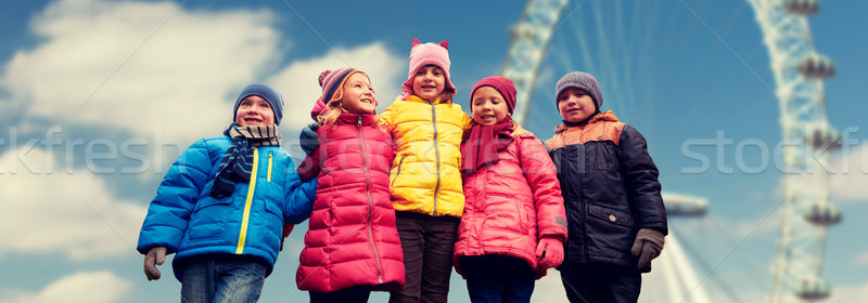 happy little children faces over ferry wheel Stock photo © dolgachov