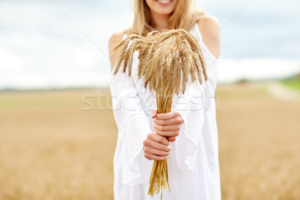 close up of happy woman with cereal spikelets Stock photo © dolgachov