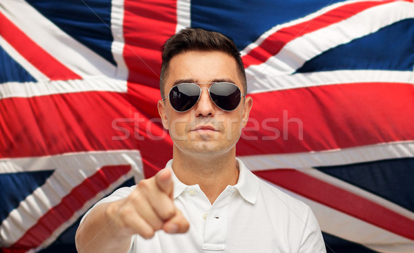 man in shades pointing finger over brittish flag Stock photo © dolgachov
