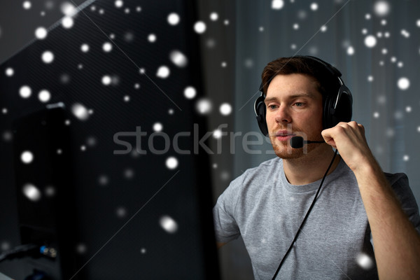 man in headset playing computer video game at home Stock photo © dolgachov