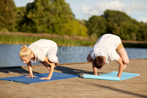 Stock photo: couple making yoga crow pose outdoors