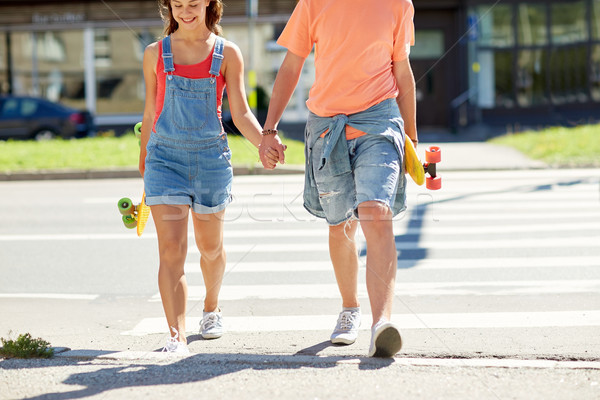 teenage couple with skateboards at city crosswalk Stock photo © dolgachov