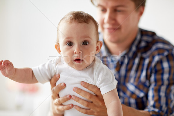 Stock photo: happy young father with little baby at home