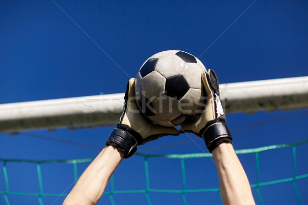 goalkeeper with ball at football goal over sky Stock photo © dolgachov