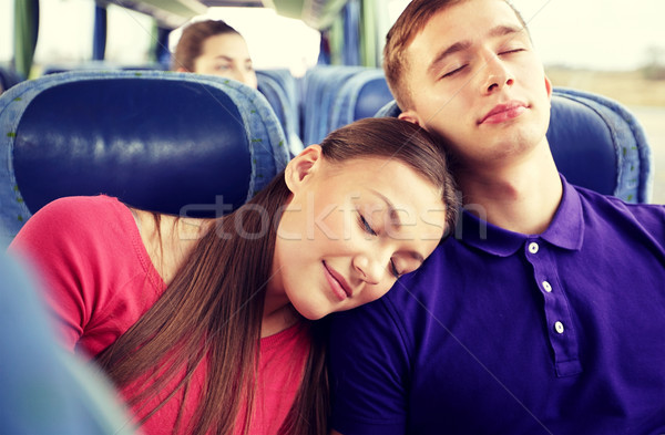 happy couple or passengers sleeping in travel bus Stock photo © dolgachov