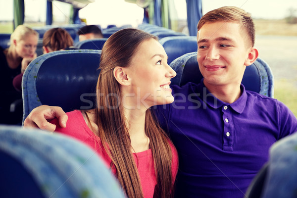 happy teenage couple or passengers in travel bus Stock photo © dolgachov