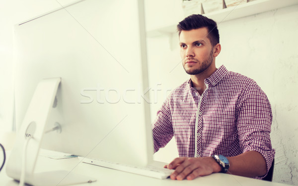 creative man or student with computer at office Stock photo © dolgachov