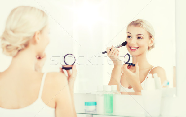 woman with makeup brush and blush at bathroom Stock photo © dolgachov