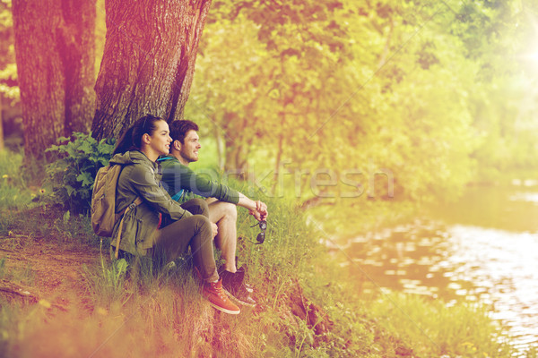 smiling couple with backpacks in nature Stock photo © dolgachov