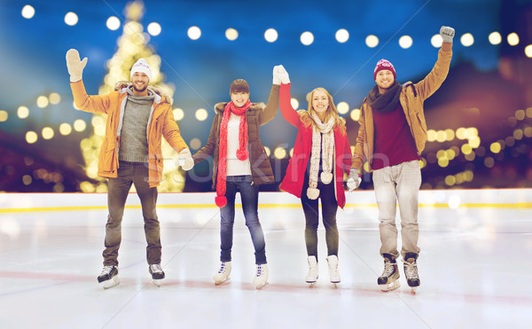 happy friends waving hands on outdoor skating rink Stock photo © dolgachov