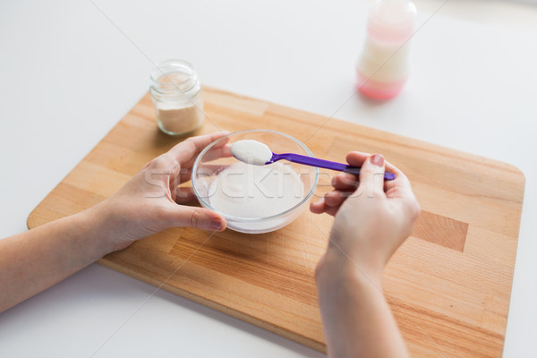 hands with spoon and jar making baby cereal Stock photo © dolgachov