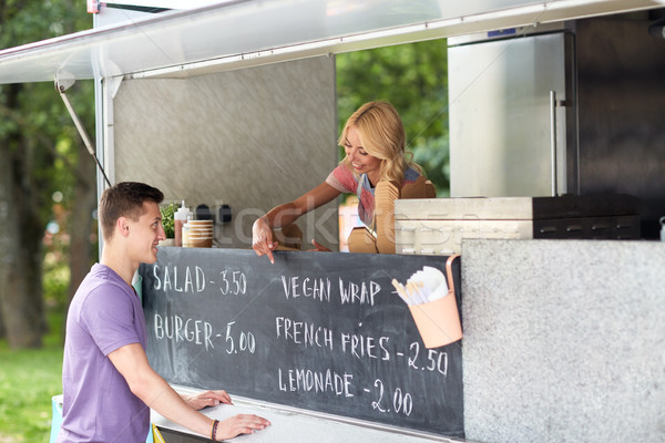 saleswoman at food truck serving male customer Stock photo © dolgachov