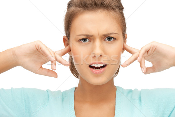 woman with fingers in ears Stock photo © dolgachov