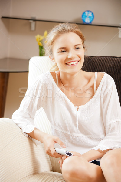 happy teenage girl with TV remote Stock photo © dolgachov
