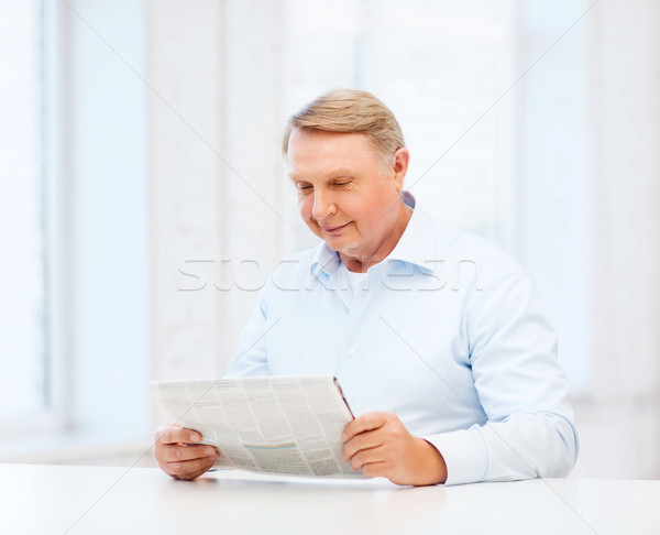 old man at home reading newspaper Stock photo © dolgachov