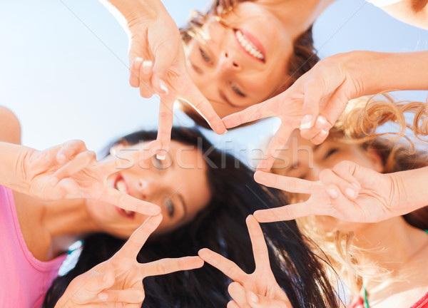 Dziewcząt patrząc w dół palec pięć gest Zdjęcia stock © dolgachov