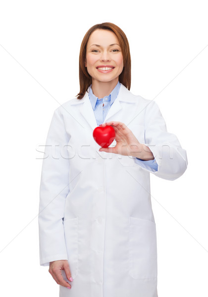 smiling female doctor with heart Stock photo © dolgachov
