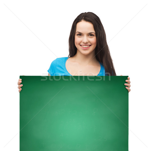 smiling young girl with blank white board Stock photo © dolgachov