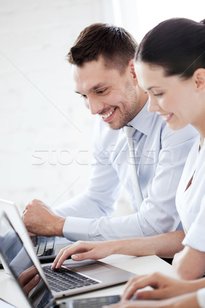 man and woman working with laptop in office Stock photo © dolgachov