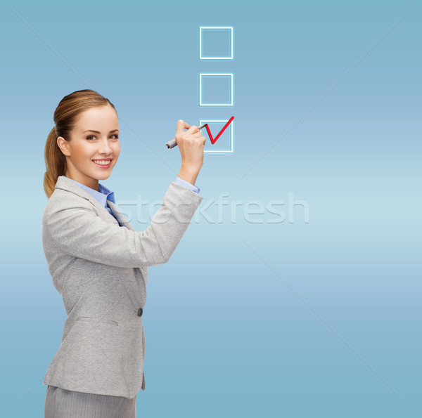 businesswoman writing something in air with marker Stock photo © dolgachov