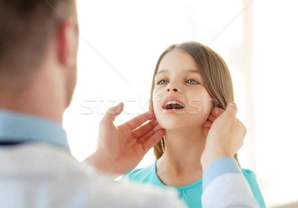 male doctor checks little girl lymph nodes Stock photo © dolgachov