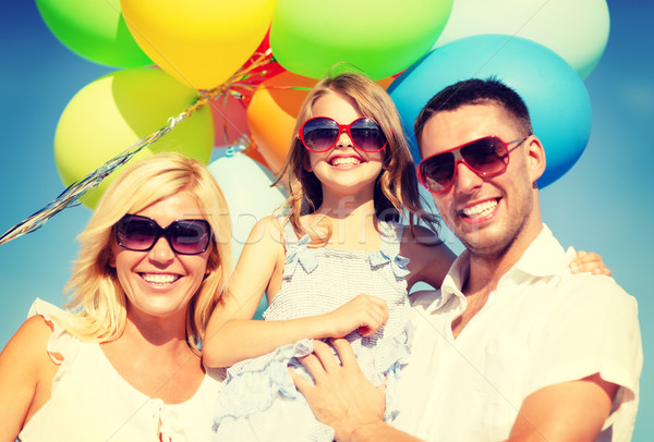 happy family with colorful balloons outdoors Stock photo © dolgachov
