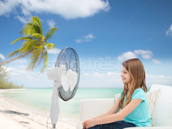 smiling little girl with big fan at home Stock photo © dolgachov
