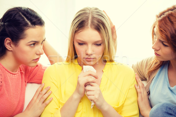 Stock photo: two teenage girls comforting another after breakup