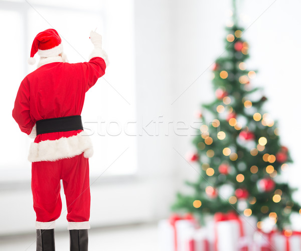 man in costume of santa claus writing something Stock photo © dolgachov