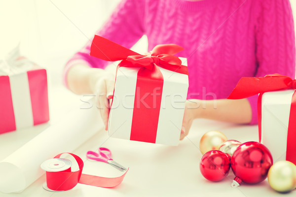 close up of woman decorating christmas presents Stock photo © dolgachov