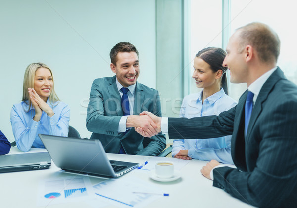two businessman shaking hands in office Stock photo © dolgachov