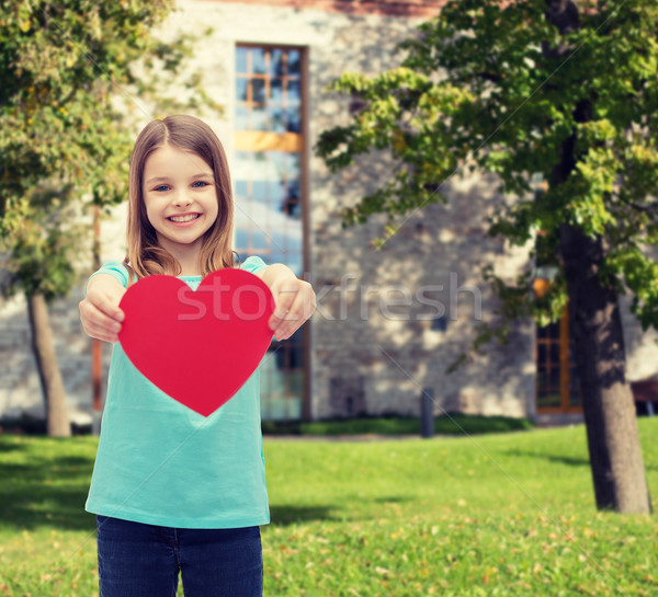 smiling little girl giving red heart Stock photo © dolgachov