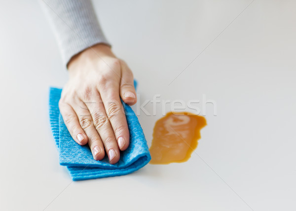 close up of hand cleaning table surface with cloth Stock photo © dolgachov