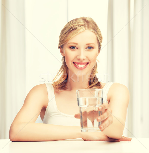 Genç gülümseyen kadın cam su kadın Stok fotoğraf © dolgachov
