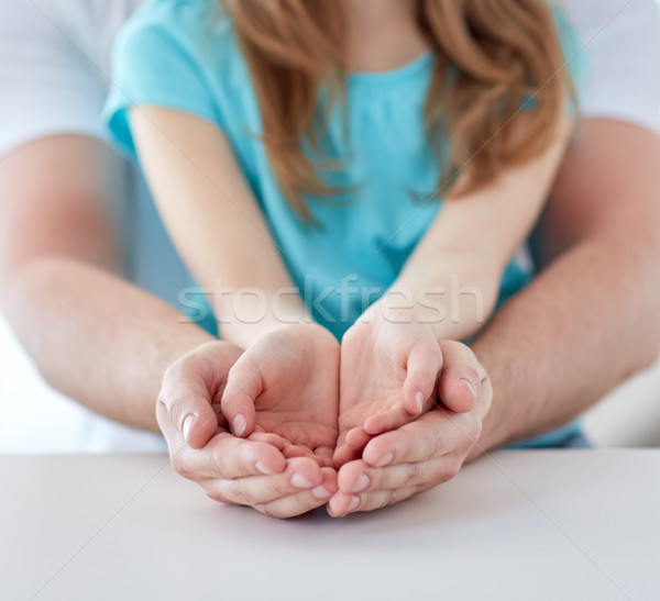 close up of man and girl with cupped hands at home Stock photo © dolgachov