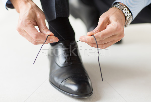 close up of man leg and hands tying shoe laces Stock photo © dolgachov