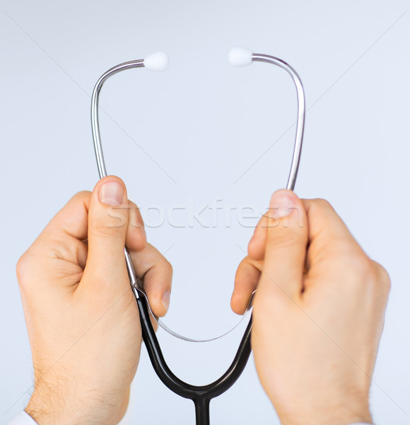 doctor hand with stethoscope listening something Stock photo © dolgachov