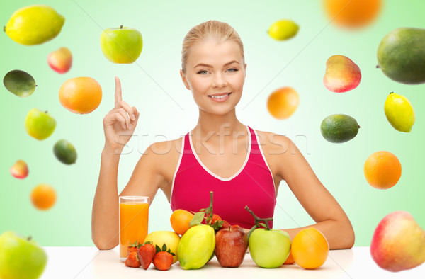 woman with juice and fruits pointing finger up Stock photo © dolgachov