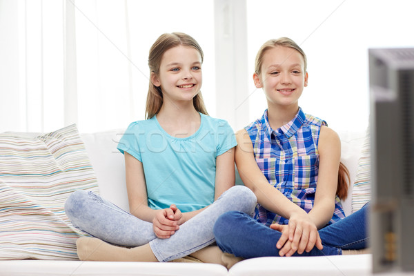 two happy little girls watching tv at home Stock photo © dolgachov
