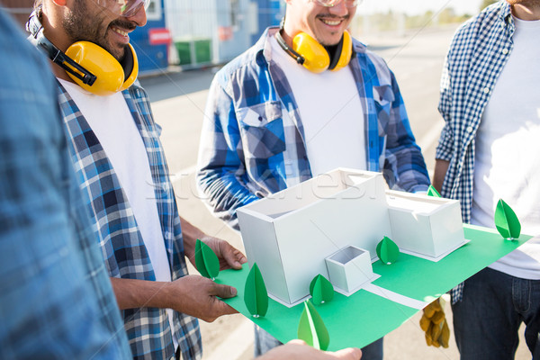 close up of builders with paper house model Stock photo © dolgachov